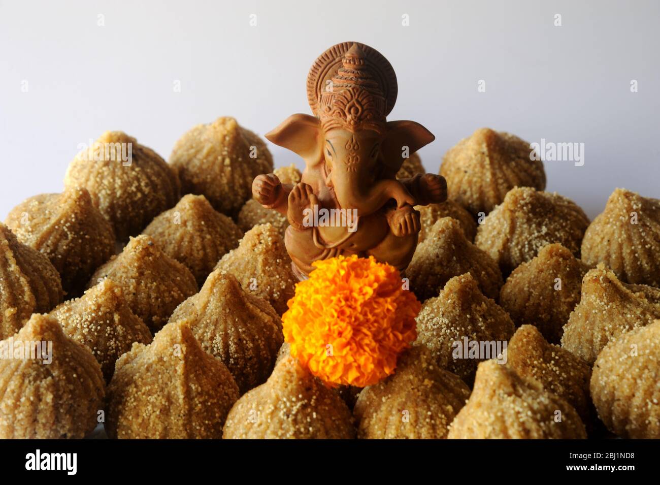 Mumbai, Maharashtra, India- Asia, April, 27, 2020 - Ganesh Chaturthi Hindu God  Ganesha with laddu/modak made of wheat flour sugar and ghee Stock Photo