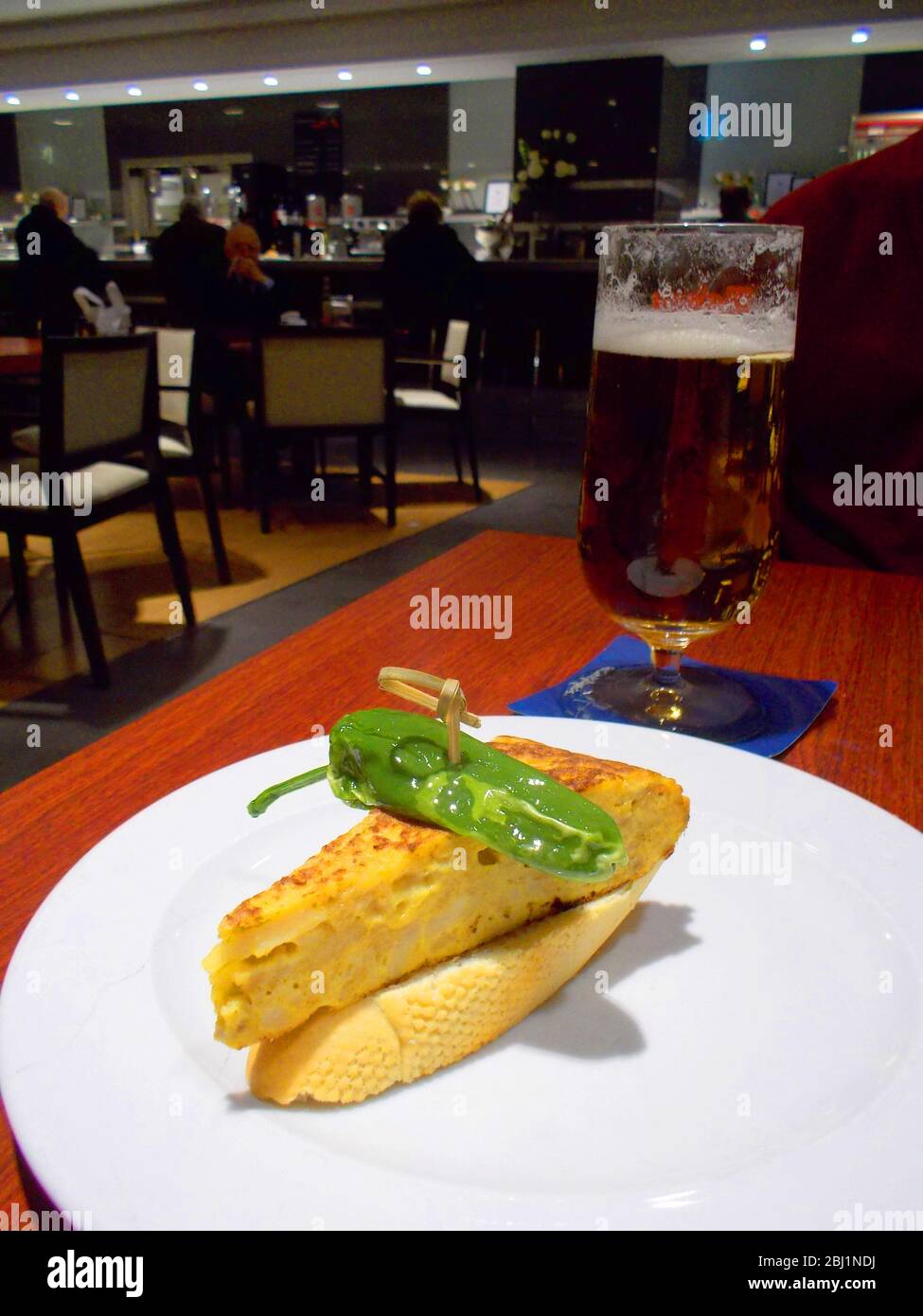 Spanish tapa: pincho de tortilla, Spanish omelet on toast with green pepper. Spain. Stock Photo