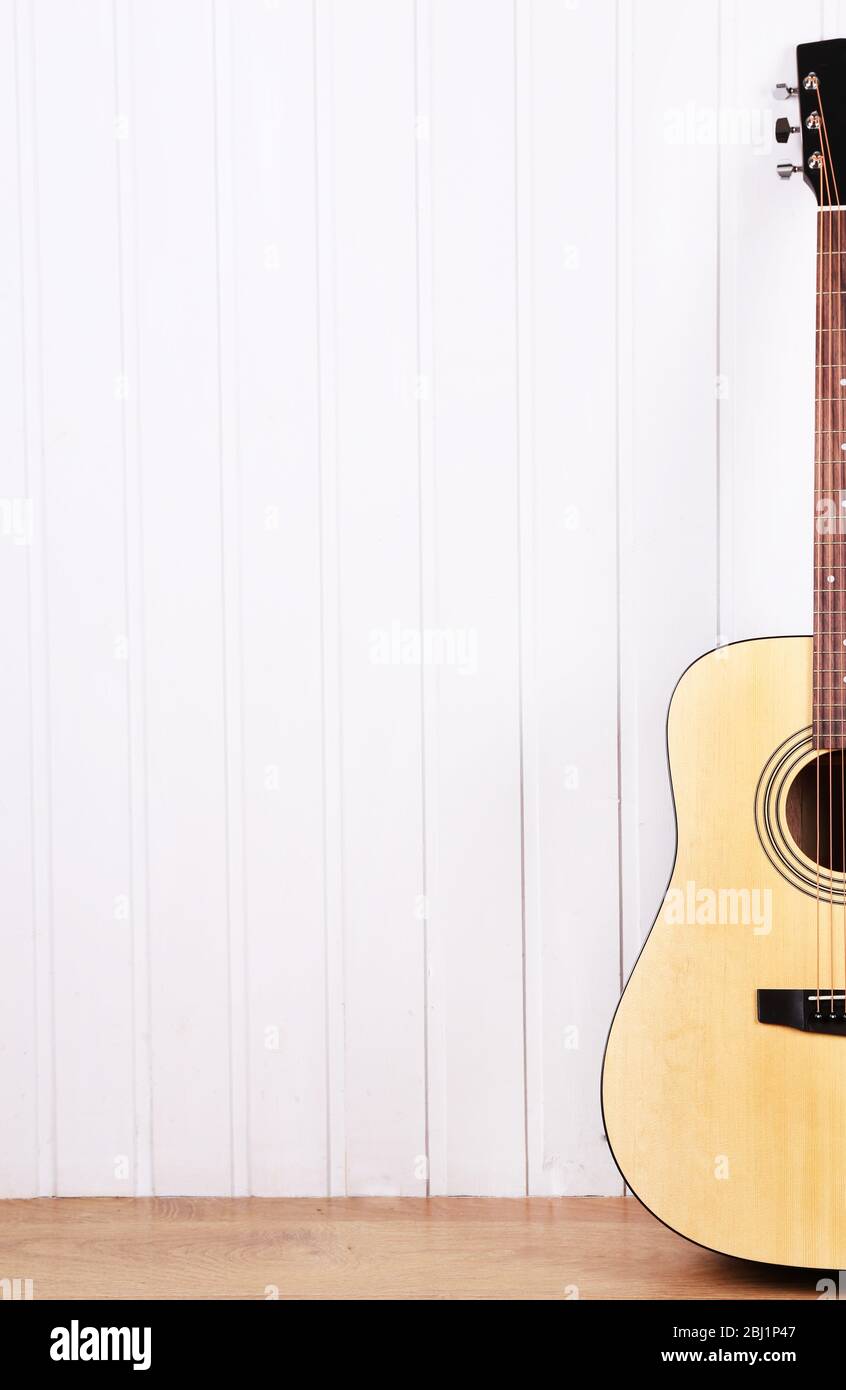 Classical guitar on white wooden wall background Stock Photo