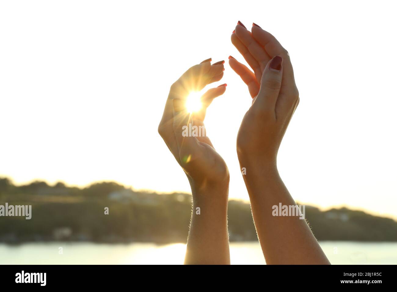 Female hands on sunny sky background Stock Photo - Alamy