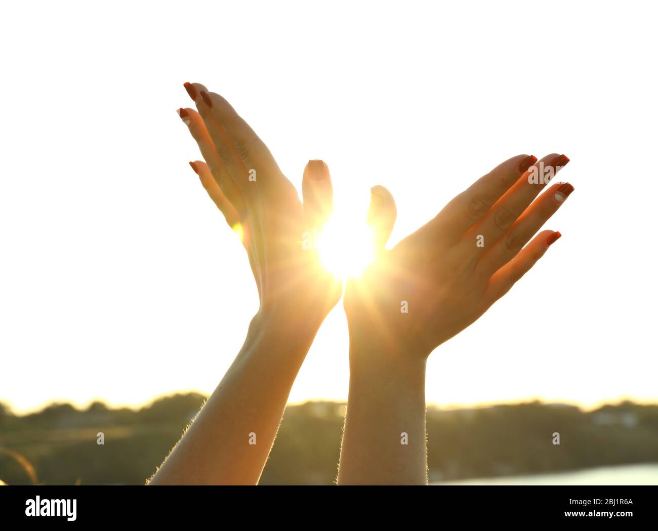 Female hands on sunny sky background Stock Photo - Alamy
