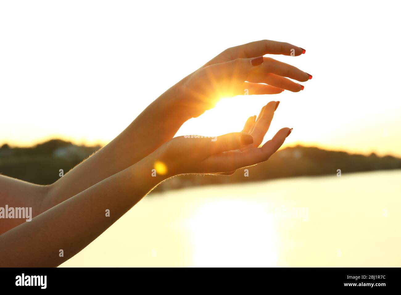 Female hands on sunny sky background Stock Photo - Alamy