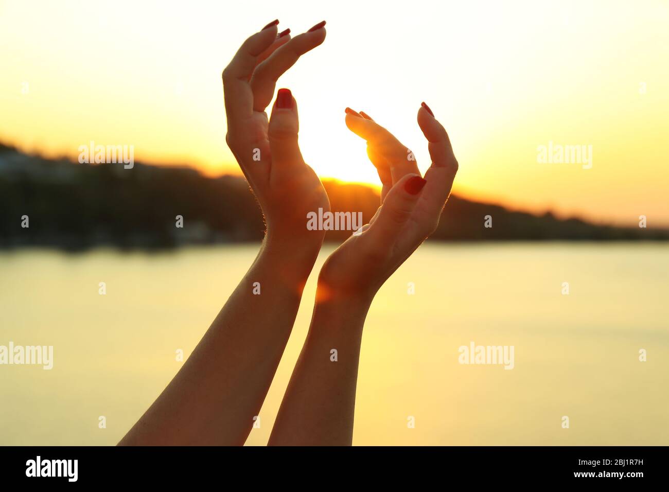 Female hands on sunny sky background Stock Photo - Alamy