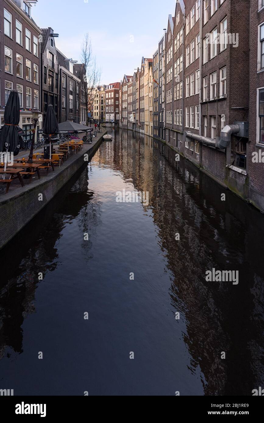 Day time view down Oudezijds Achterburgwal canal street in the world famous Red Light District of Amsterdam, Netherlands. Stock Photo