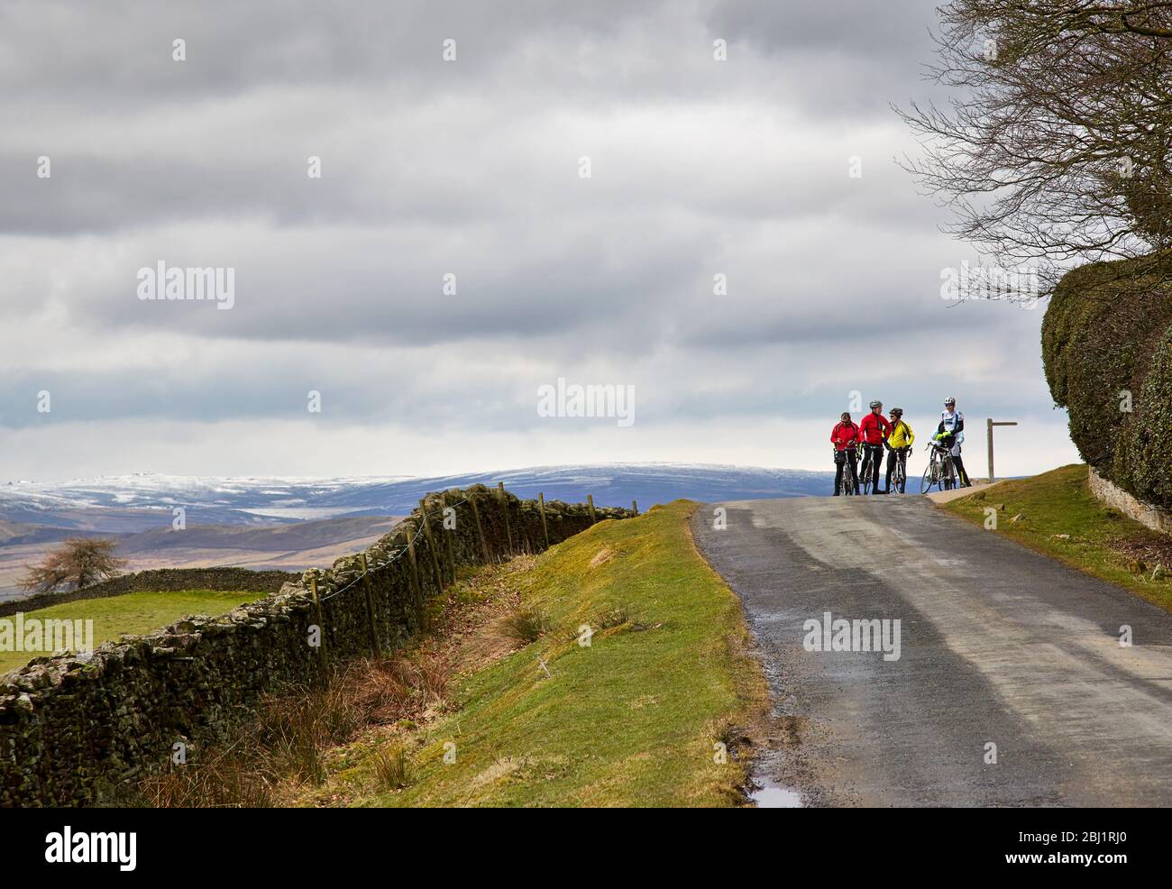 Cyclists taking a rest and gathered enjoying the view by Beamsley Beacon, Langbar Yorkshire Stock Photo