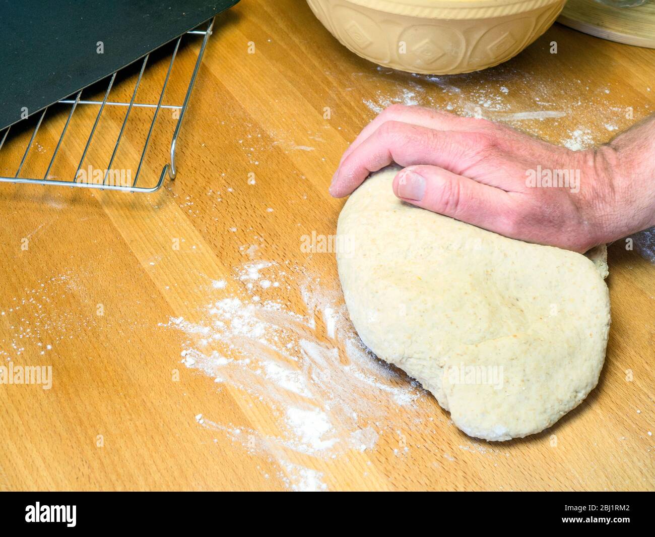Kneading oat bread dough on a floured kitchen table Stock Photo