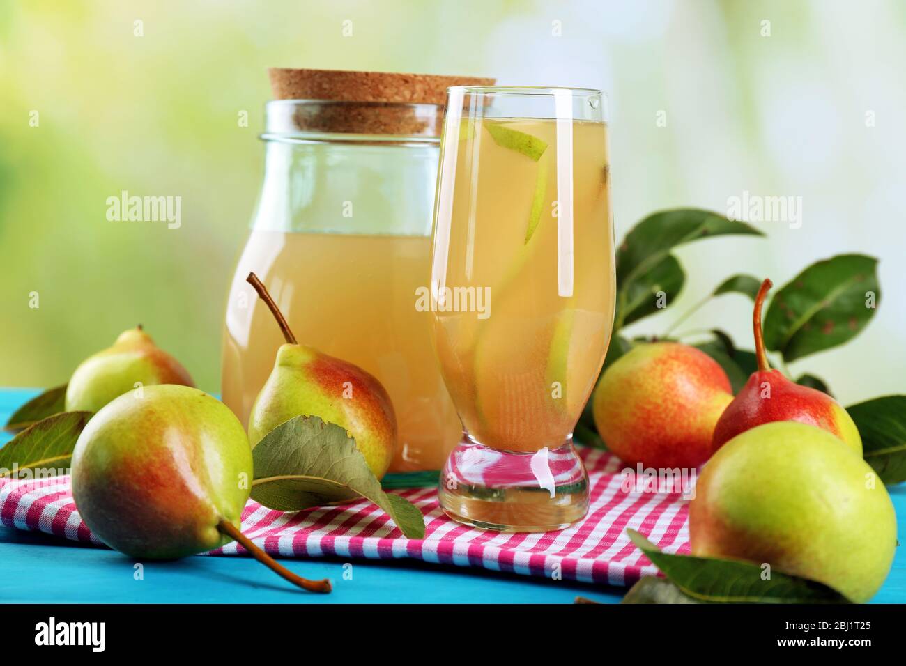 Fresh pear juice with fruit on bright background Stock Photo - Alamy