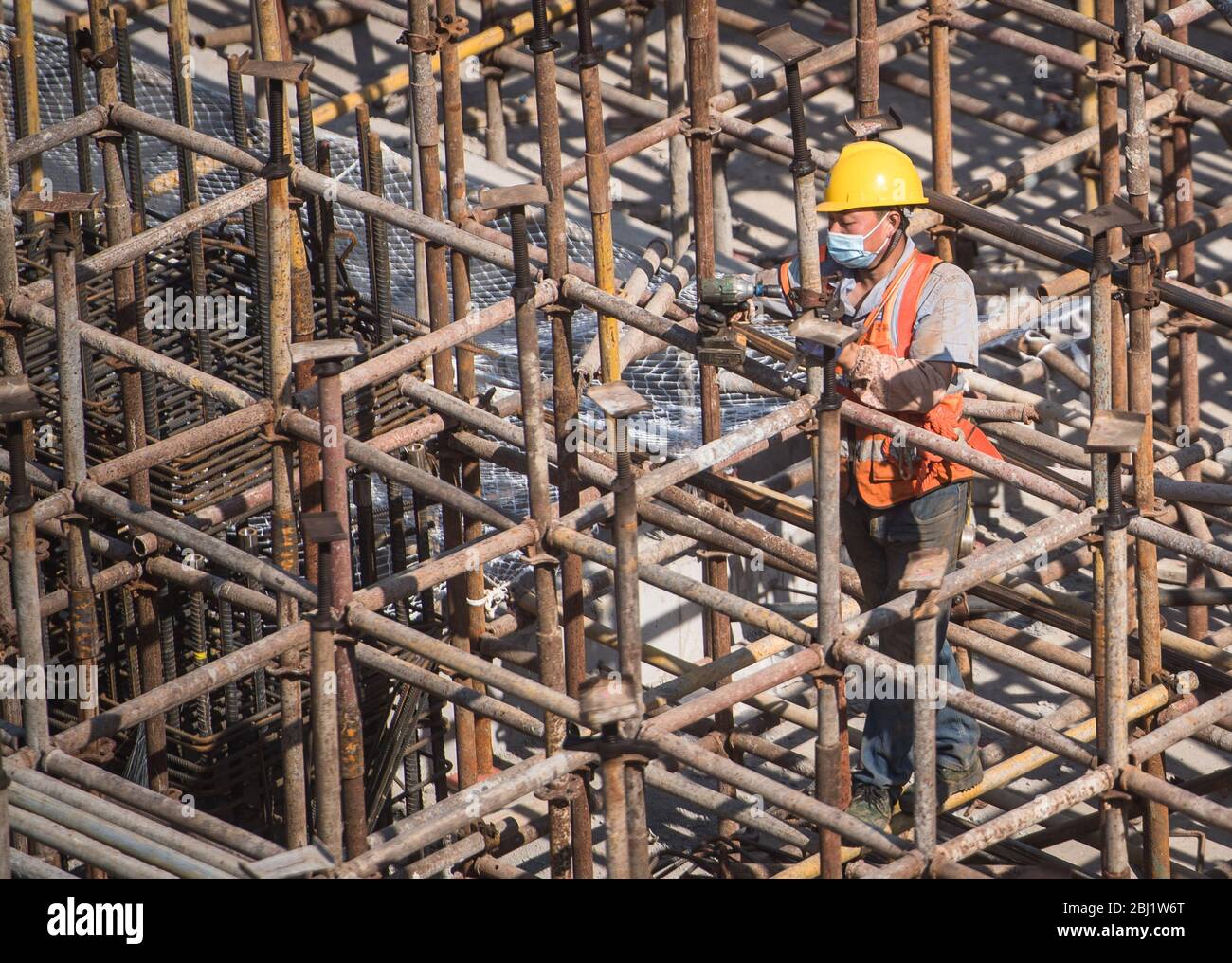 Wuhan, China's Hubei Province. 28th Apr, 2020. A worker works at the construction site of Joy City building complex in Wuhan, central China's Hubei Province, April 28, 2020. Over 800 workers from China Construction Third Engineering Bureau Co., Ltd. are busy with the construction work of the building complex. Most of them participated in the construction of the Huoshenshan and Leishenshan hospitals in Wuhan and have undergone a 14-day quarantine before they resumed to work. Credit: Xiao Yijiu/Xinhua/Alamy Live News Stock Photo