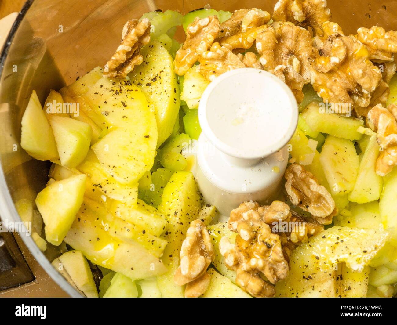 Ingredients for celery soup based on Waldorf salad in a food processor ready for blending Stock Photo