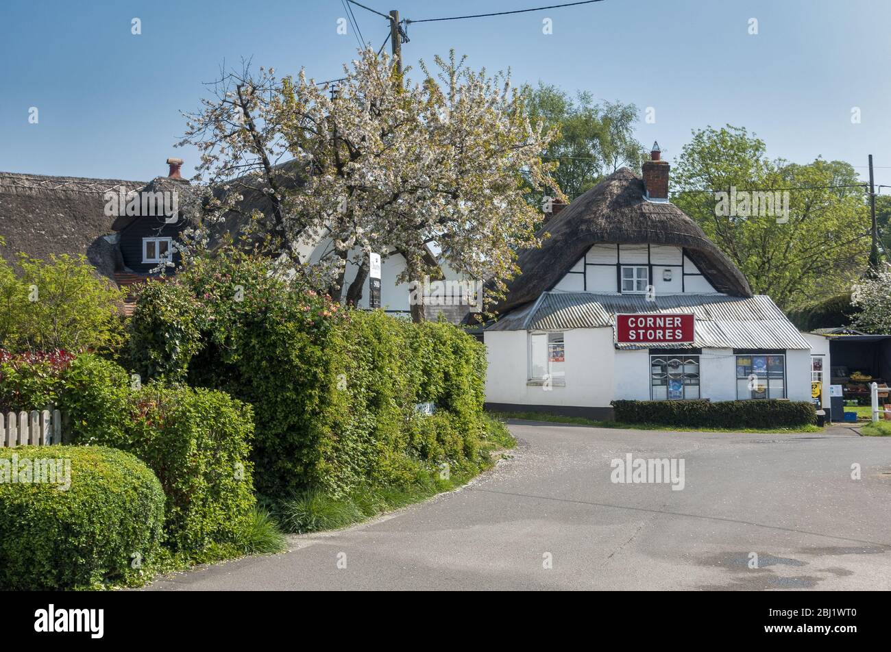 Rustic thatched cottages and the local corner store in the rural village of Kings Somborne near Stockbridge in Hampshire, England, UK Stock Photo