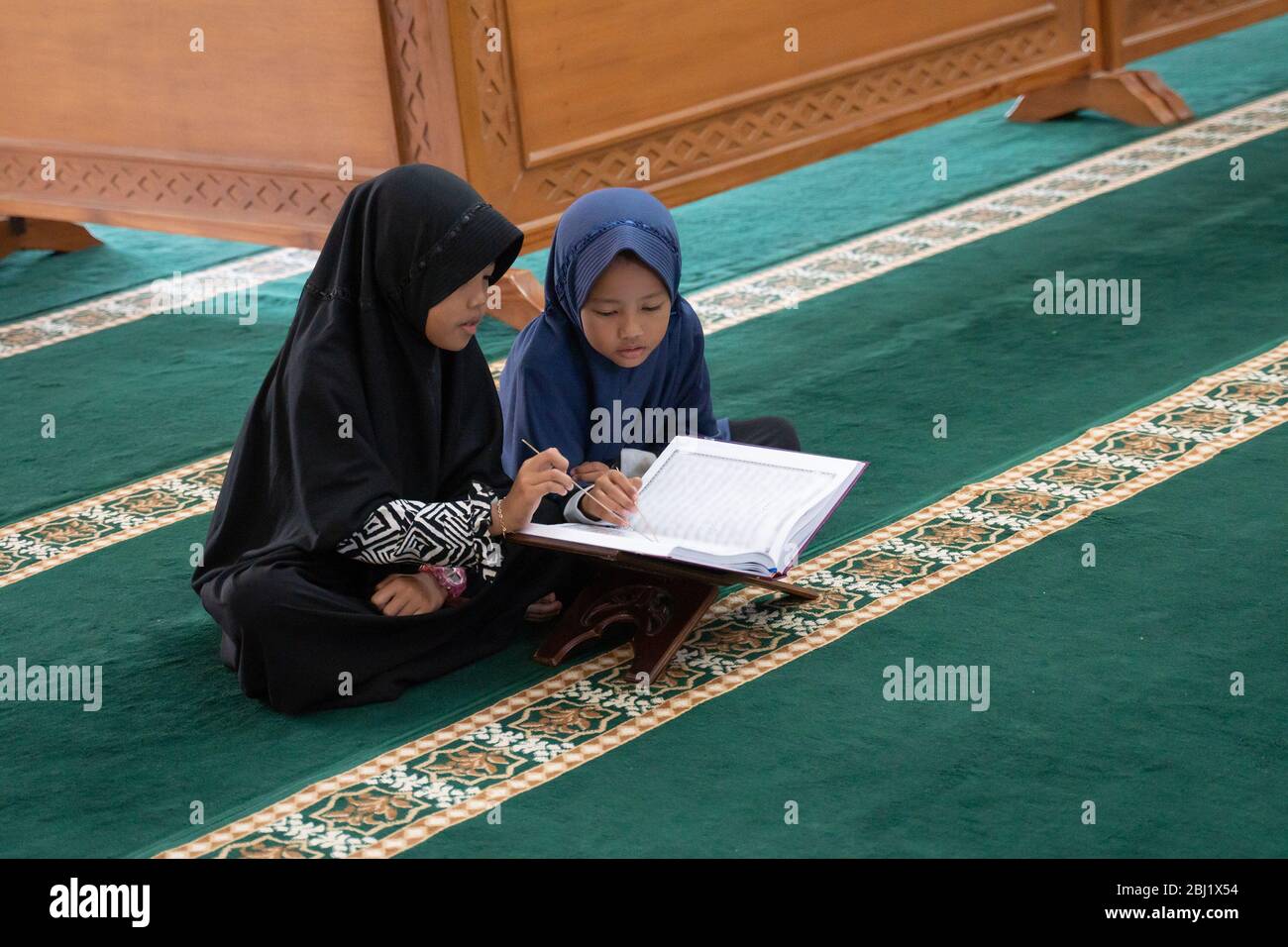 two kids read holy quran together in the mosque Stock Photo