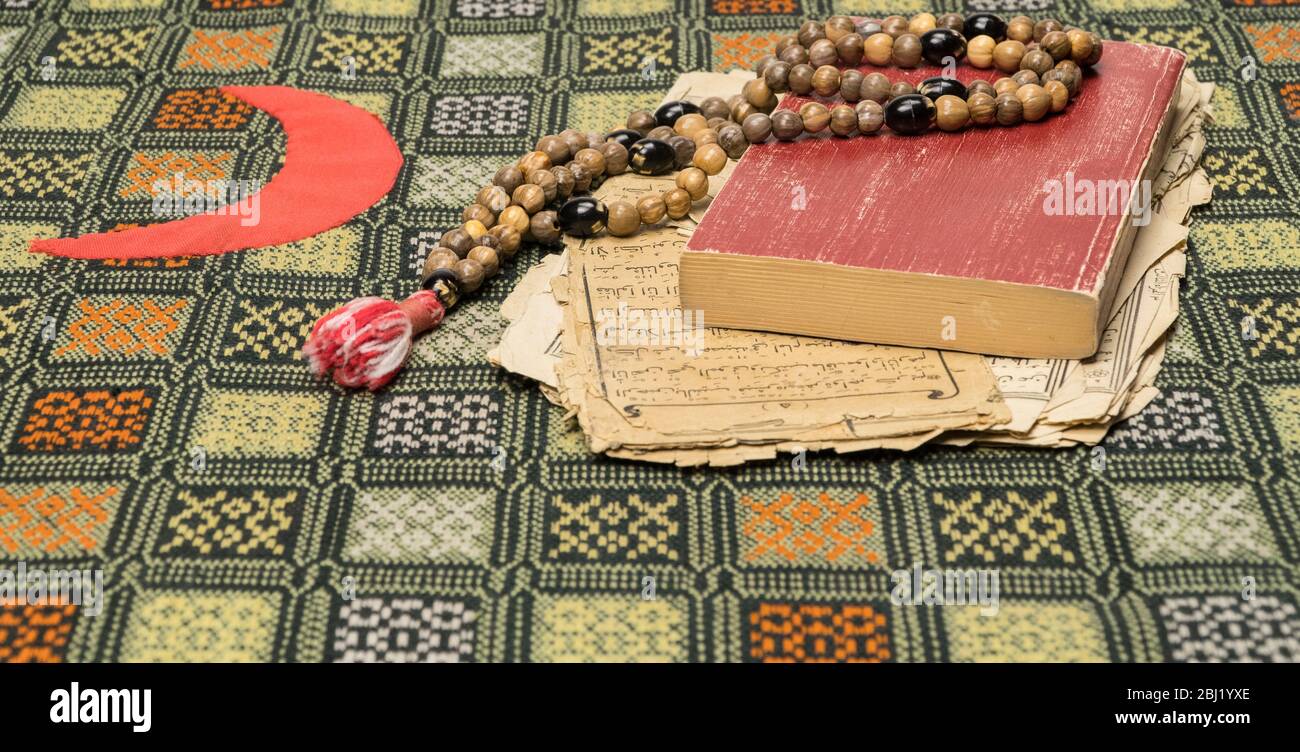 Muslim prayer beads with Quran and with sheets with ancient Arabic