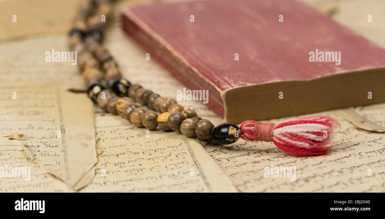 Muslim prayer beads with Quran and with sheets with ancient Arabic