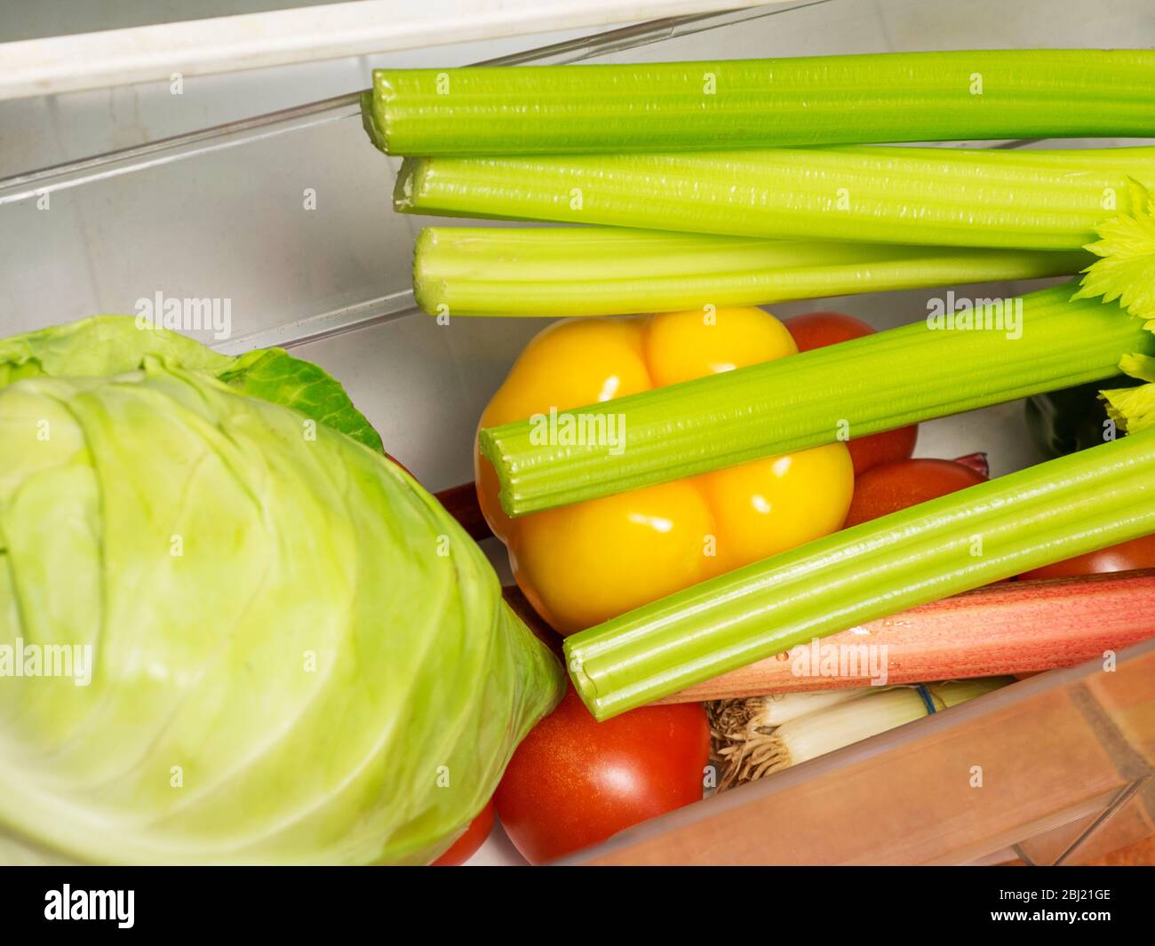 Fresh vegetables in the salad crisper drawer in a refrigerator Stock Photo
