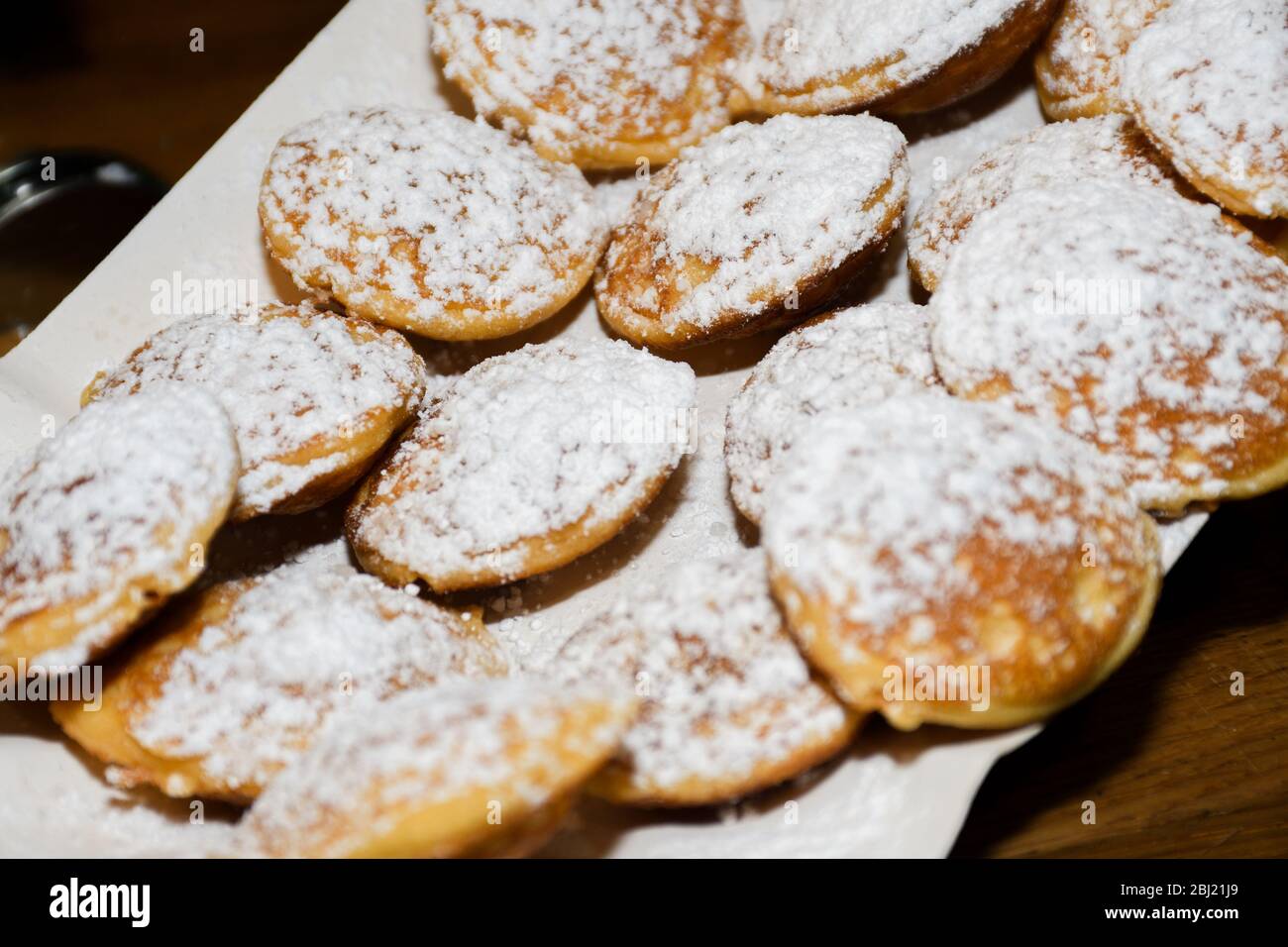 Street food dessert waffles and small pancakes with varied toppings