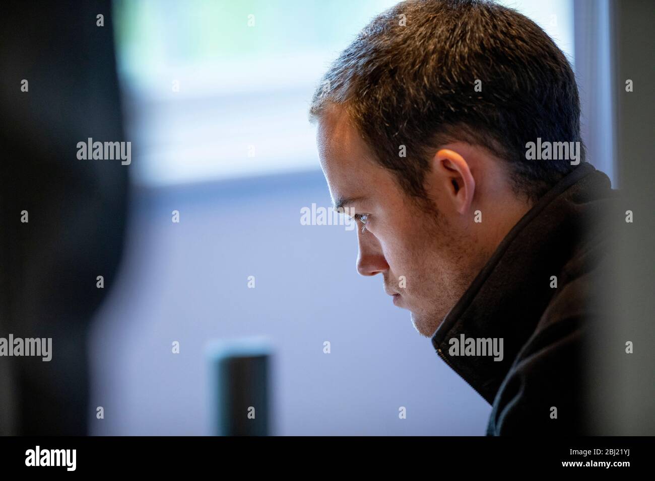 Young male primary school teacher working from home during Covid-19 lockdown Stock Photo