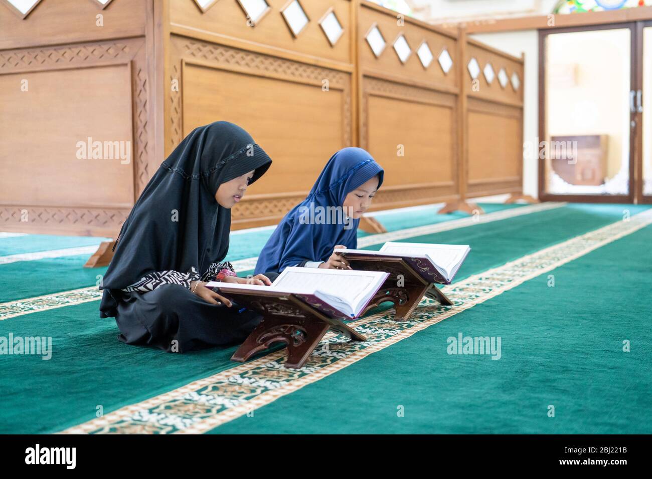 two kids read holy quran together in the mosque Stock Photo