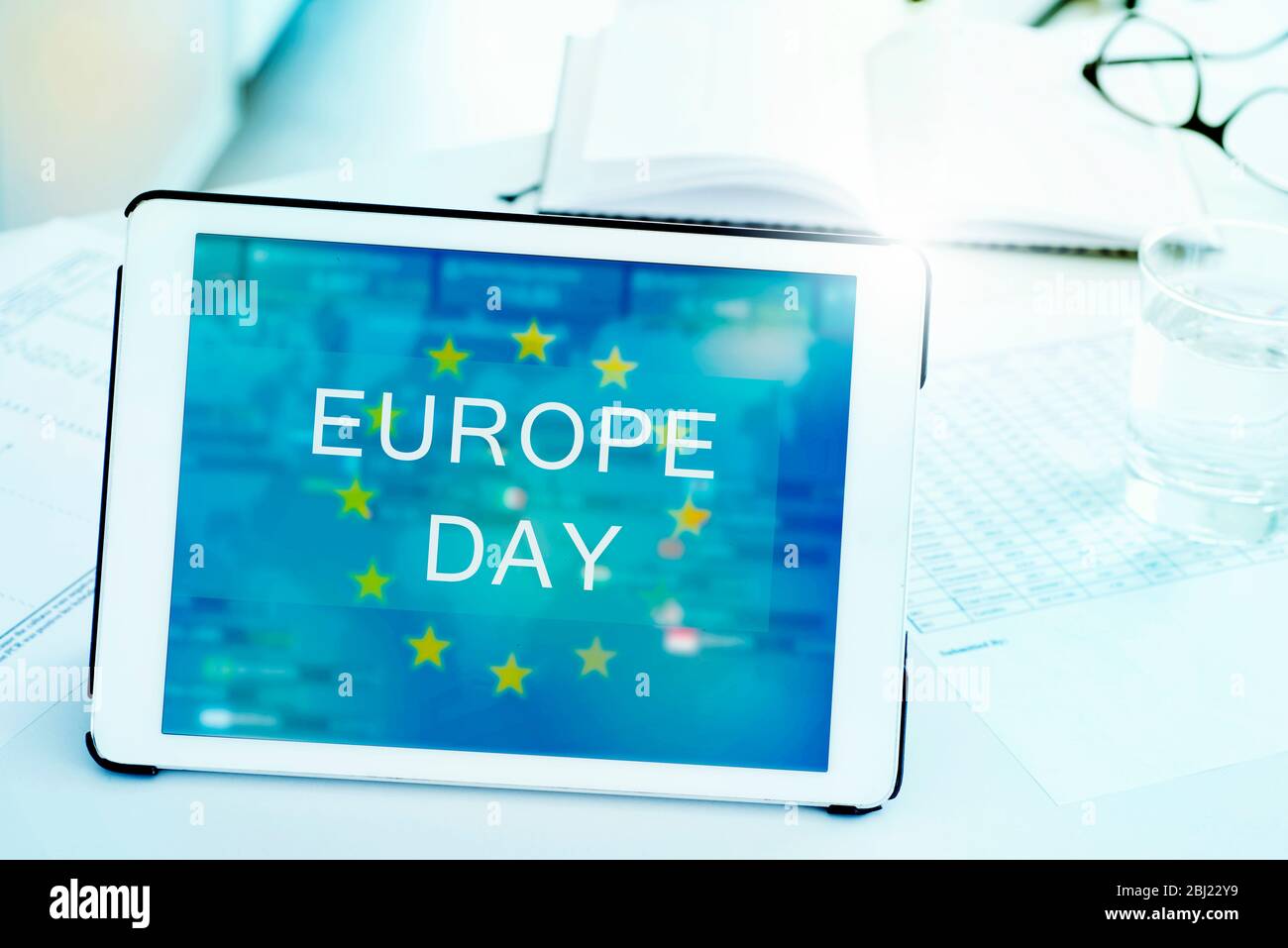 closeup of a digital tablet, with the text Europe Day and the flag of the European Union in its screen, on a white desk Stock Photo