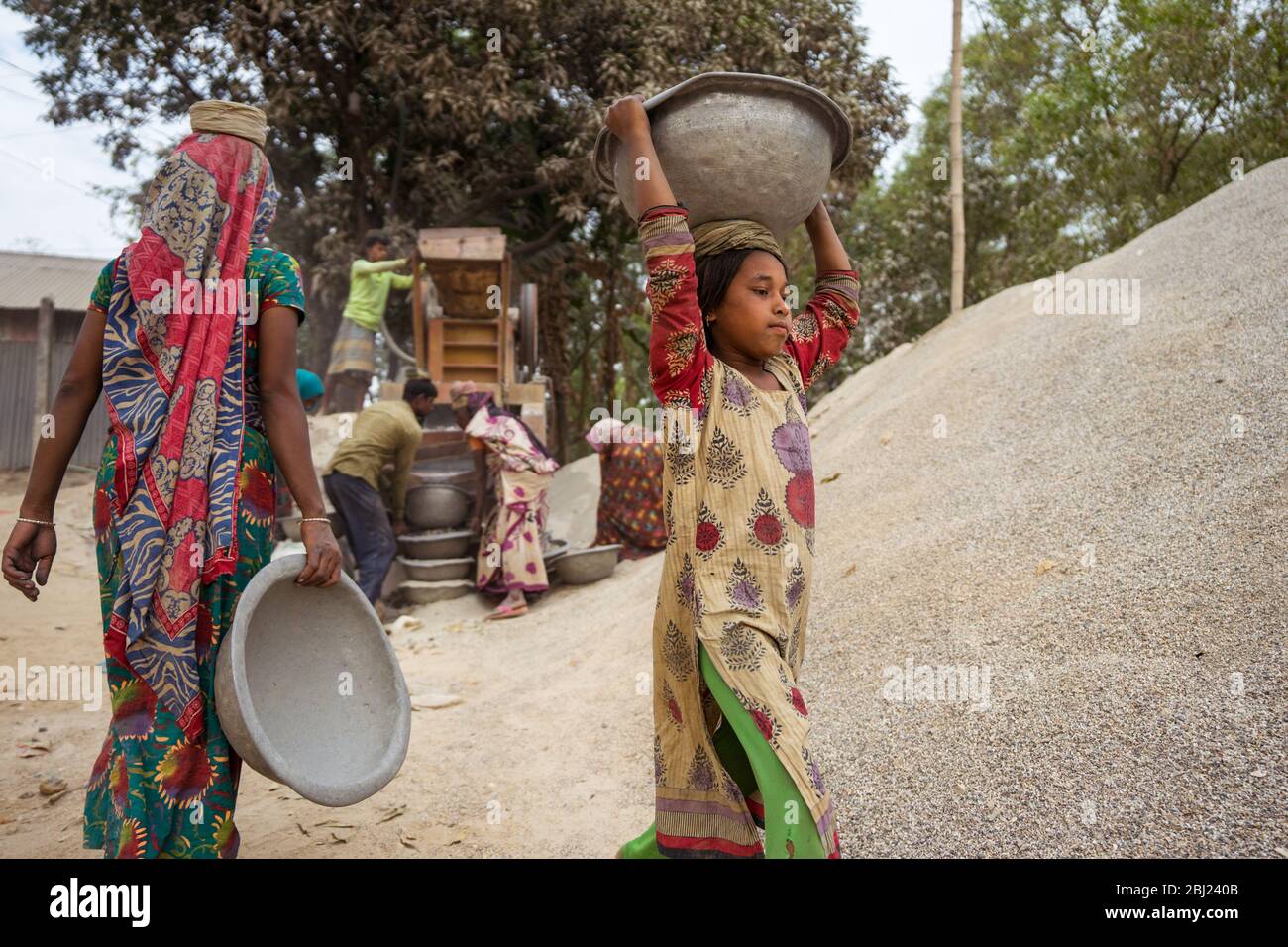 Jaflong / Bangladesh - January 28, 2019: Bengali women working hard in the stone industry for construction purposes Stock Photo
