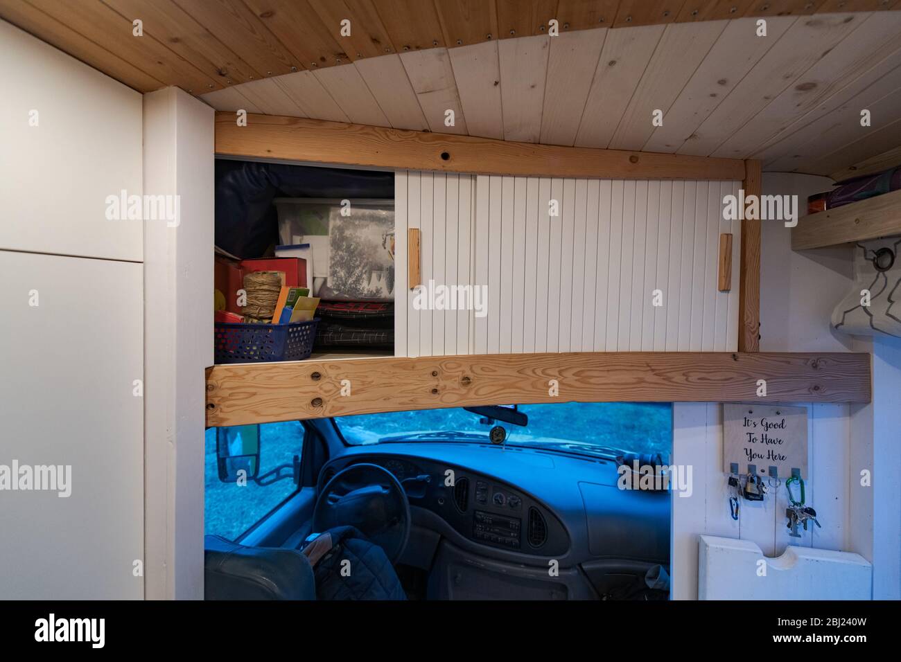Cupboard over the campervan driving cabin with sliding doors Stock