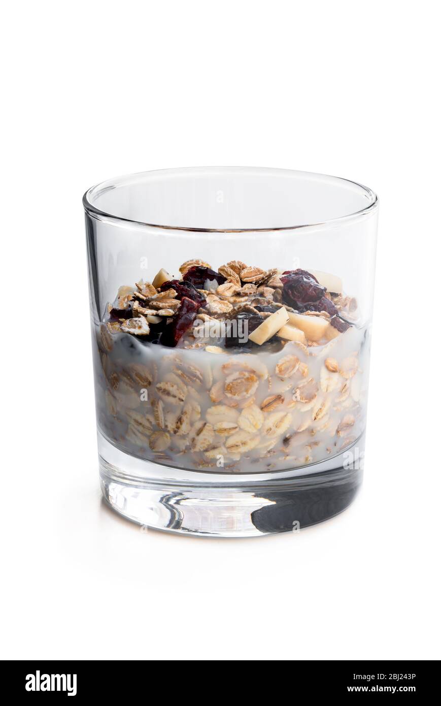Healthy breakfast muesli and granola with skimmed milk in clear glass