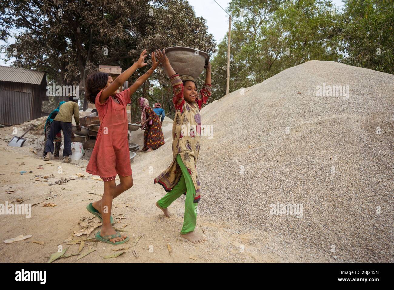 Jaflong / Bangladesh - January 28, 2019: Bengali women working hard in the stone industry for construction purposes Stock Photo
