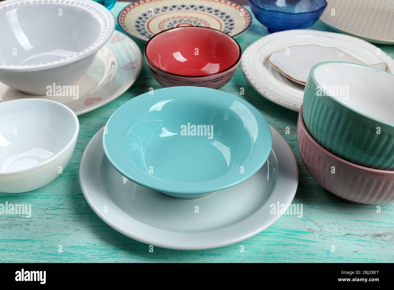 Different tableware on wooden table close up Stock Photo - Alamy