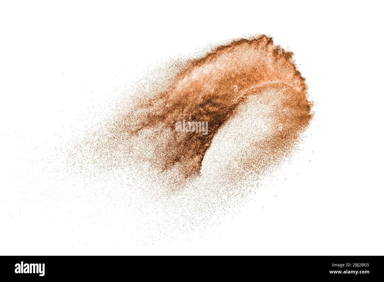 Brown powder dust cloud.Brown particles splattered on white background. Stock Photo