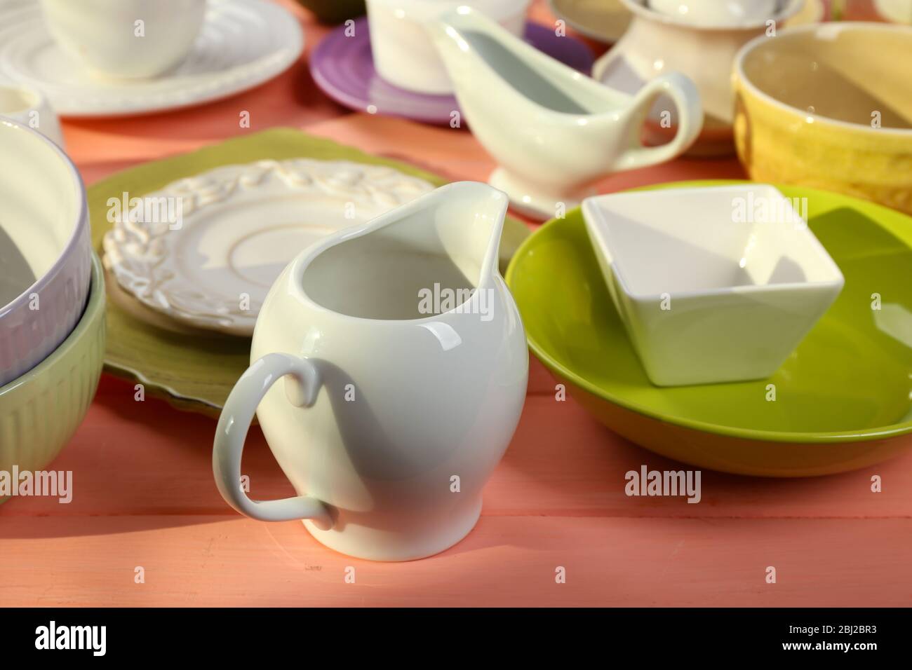 Different tableware on wooden table close up Stock Photo - Alamy