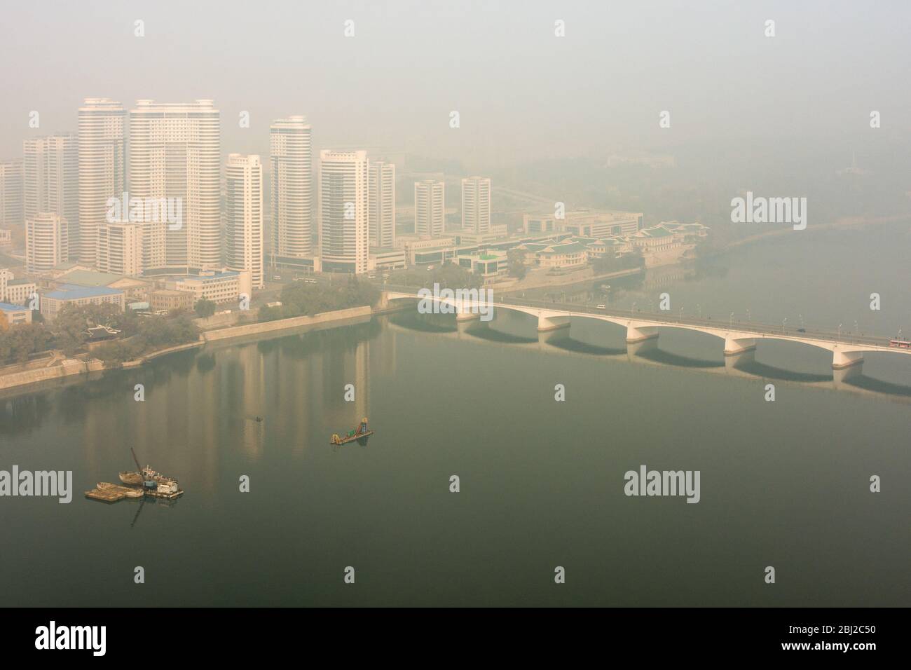 Pyongyang / DPR Korea - November 10, 2015: Pyongyang skyline with new Changjon Apartment Complex and the Taedong River on a foggy day in Pyongyang, No Stock Photo