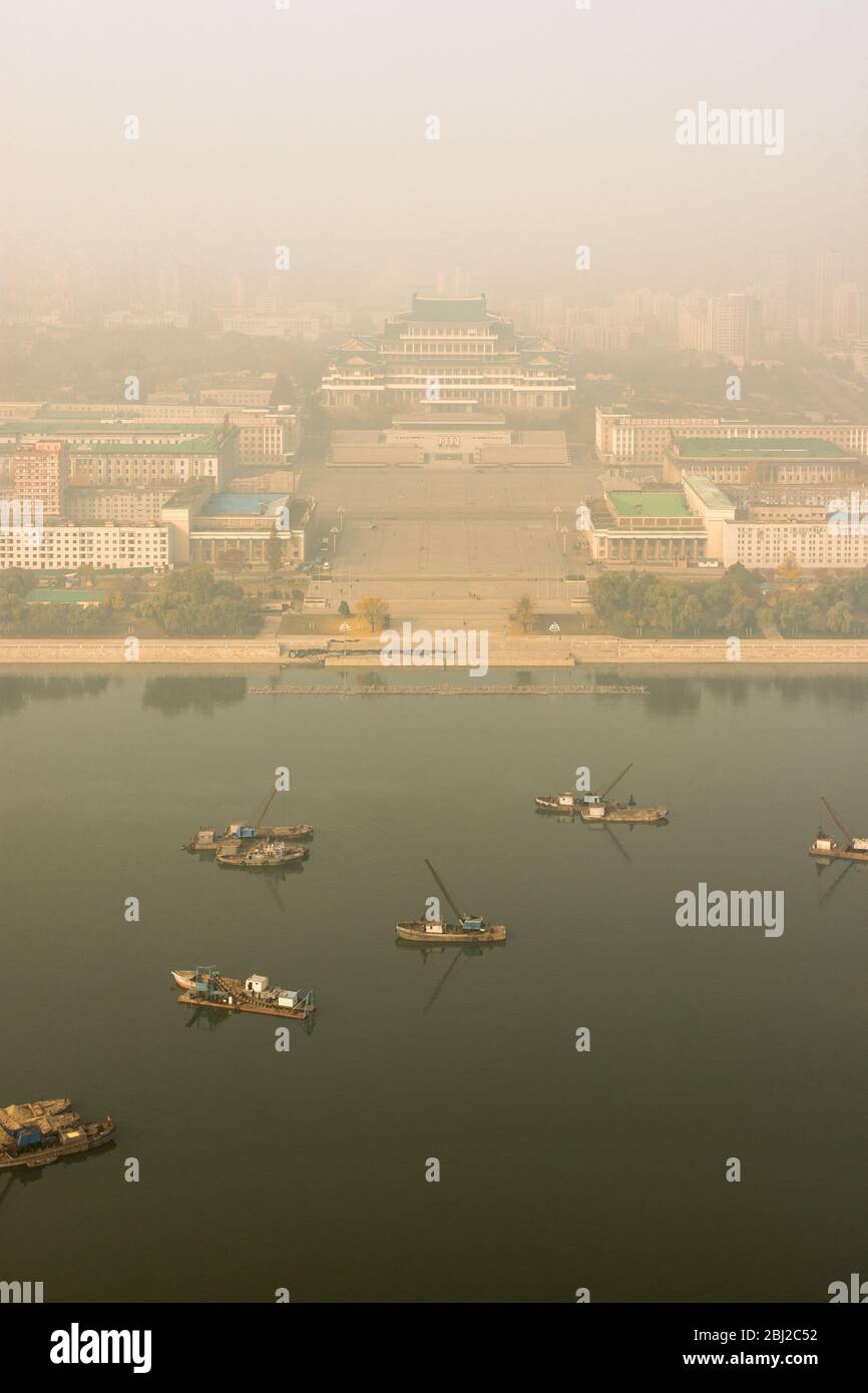Pyongyang / DPR Korea - November 10th 2015: Aerial view of Kim Il-sung Square across Taedong river in early morning fog in Pyongyang, North Korea Stock Photo