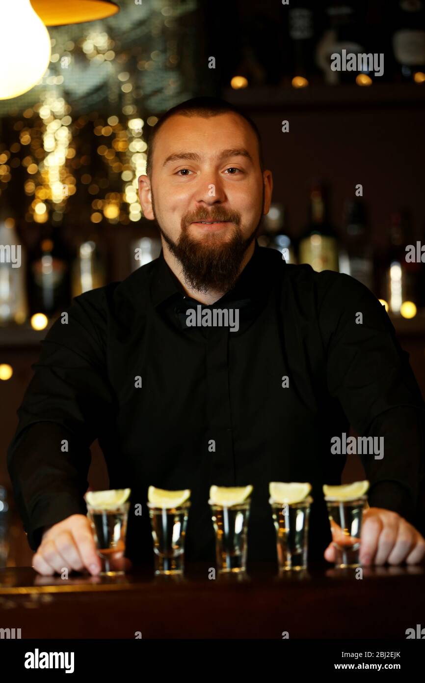 Bartender with tequila glasses Stock Photo Alamy