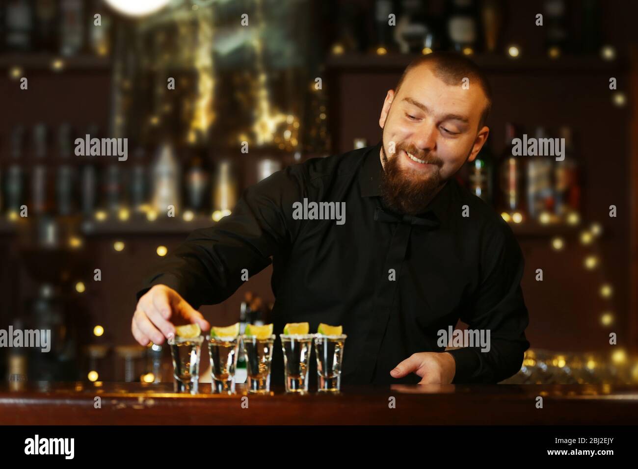 Bartender with tequila glasses Stock Photo Alamy
