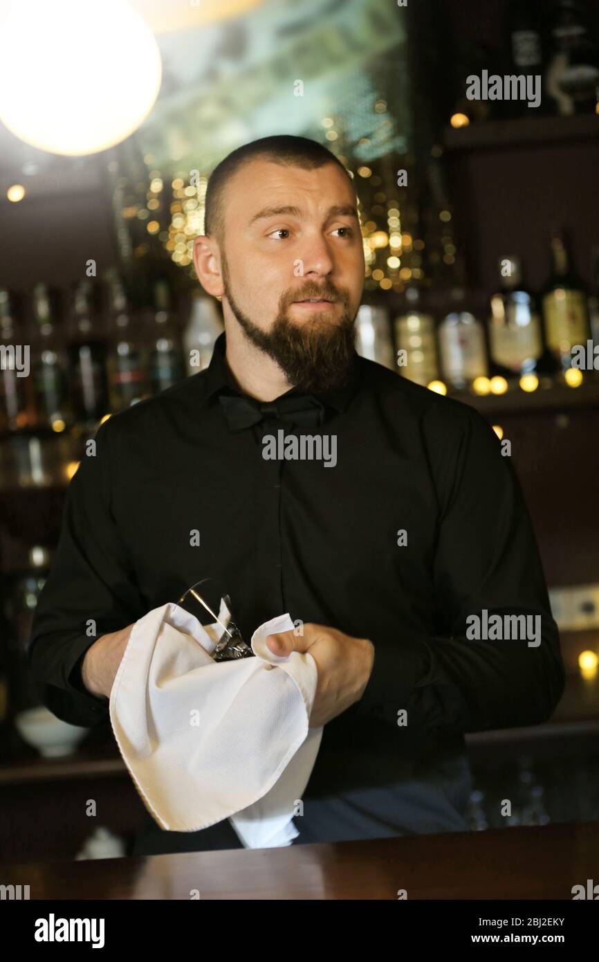 Bartender wipes glasses at work Stock Photo Alamy