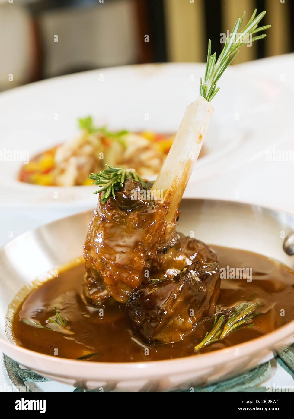 Slow Cooked Lamb shank braised in an onion jus and Red Wine Sauce Stock Photo Alamy