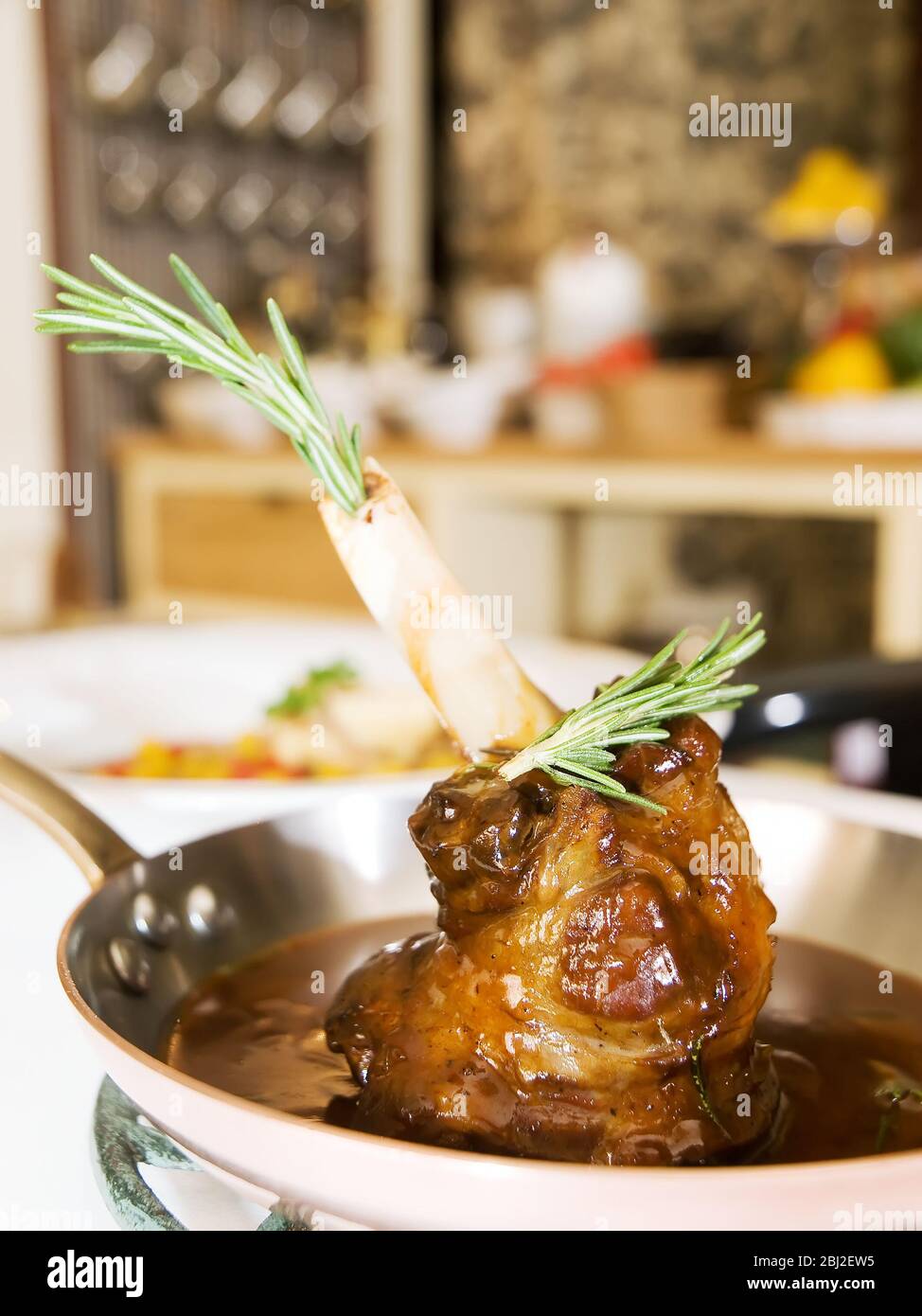 Slow Cooked Lamb shank braised in an onion jus and Red Wine Sauce Stock Photo