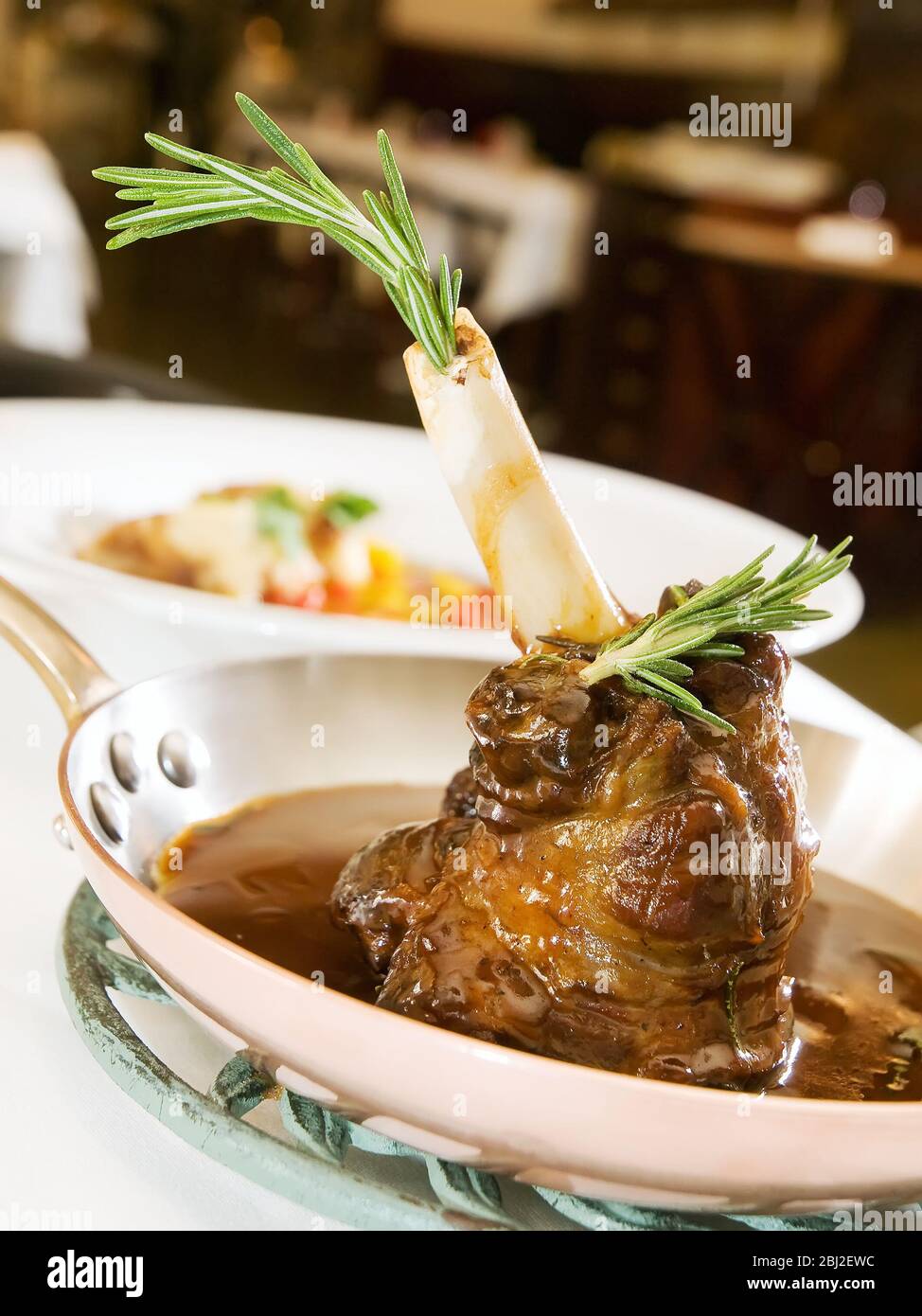 Slow Cooked Lamb shank braised in an onion jus and Red Wine Sauce Stock Photo Alamy