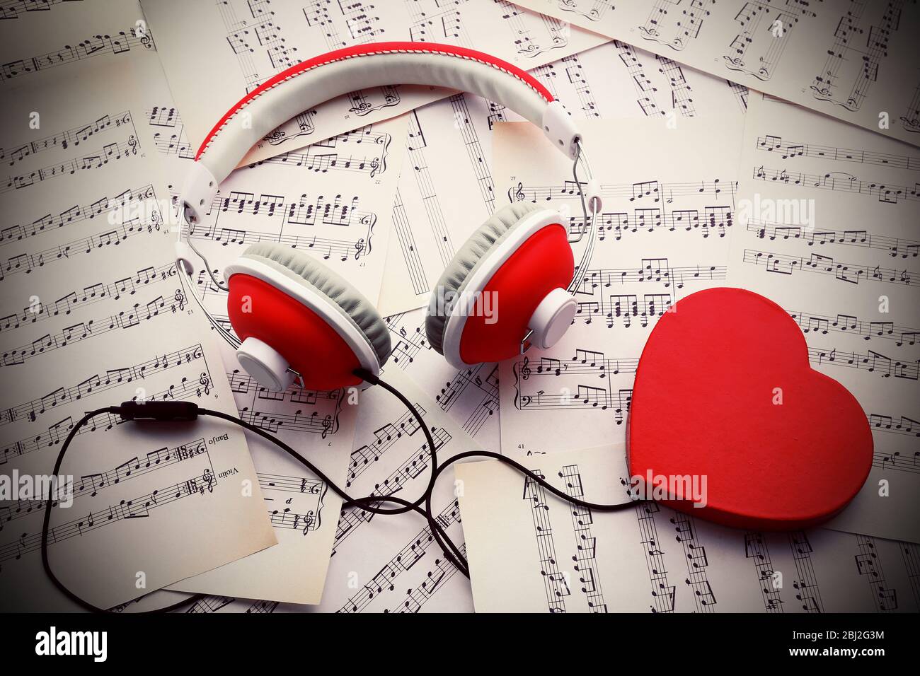 Earphones With Red Heart On Music Notes Background Stock Photo Alamy