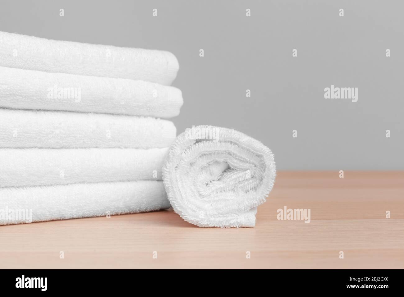 https://c8.alamy.com/comp/2BJ2GX0/clean-soft-towels-on-color-background-close-up-2BJ2GX0.jpg