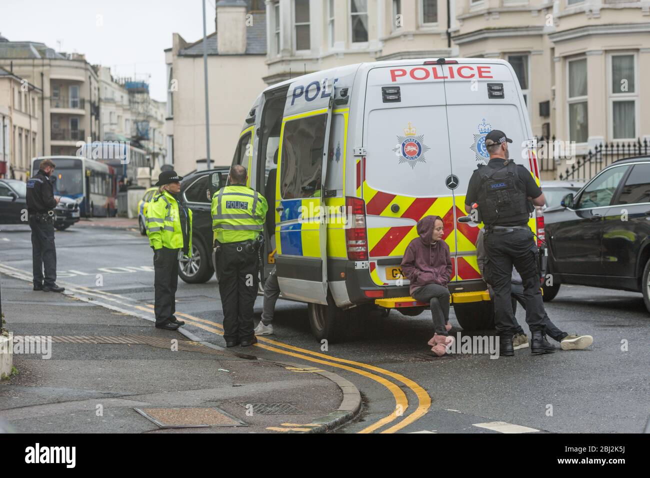 Eastbourne, England. 28 Apr 2020. Police stand by van with suspects ...