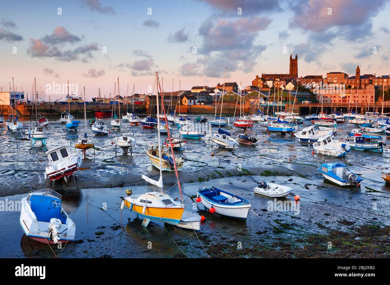 Penzance Harbour at low tide lit by the early morning sun Stock Photo