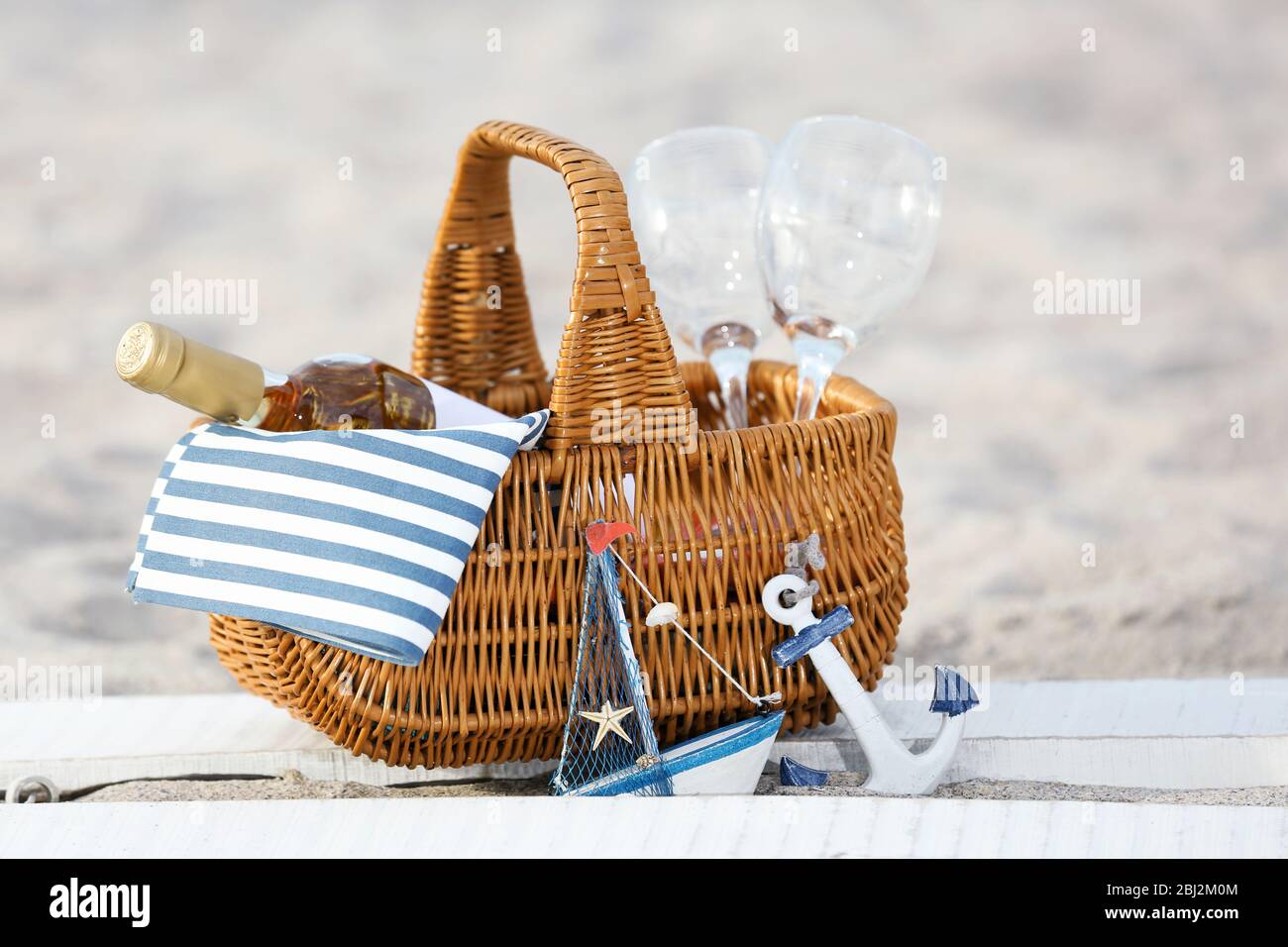 Picnic basket with bottle of wine on sand beach Stock Photo - Alamy