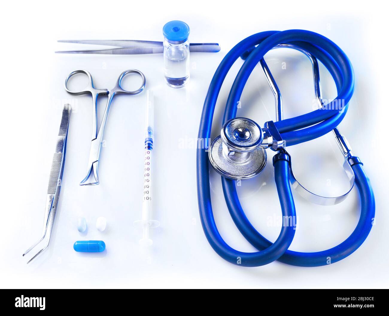 Stethoscope with medical equipment on white background, close up