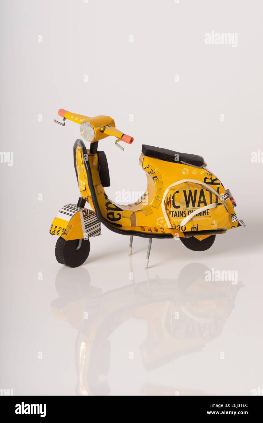 Toy model vespa scooter made from Schweppes yellow tonic water cans; Stock Photo