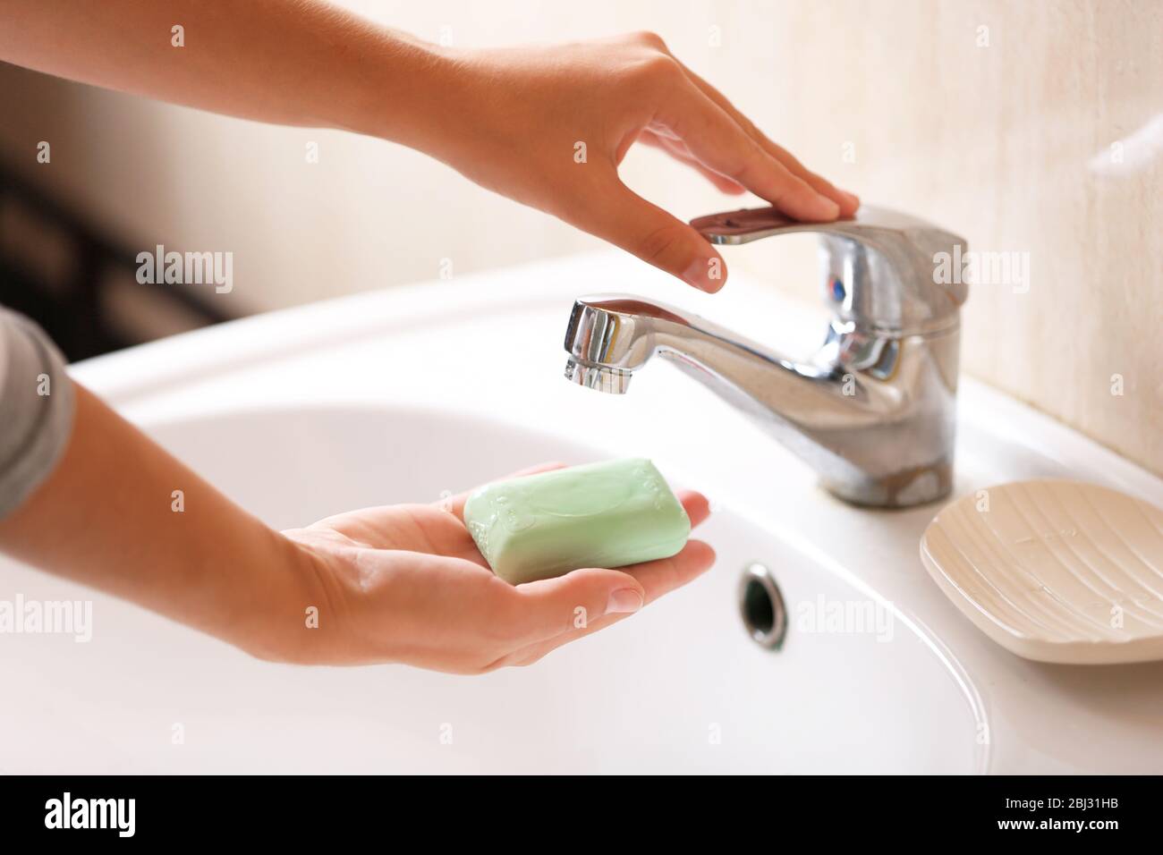 Washing of hands with soap under running water Stock Photo - Alamy