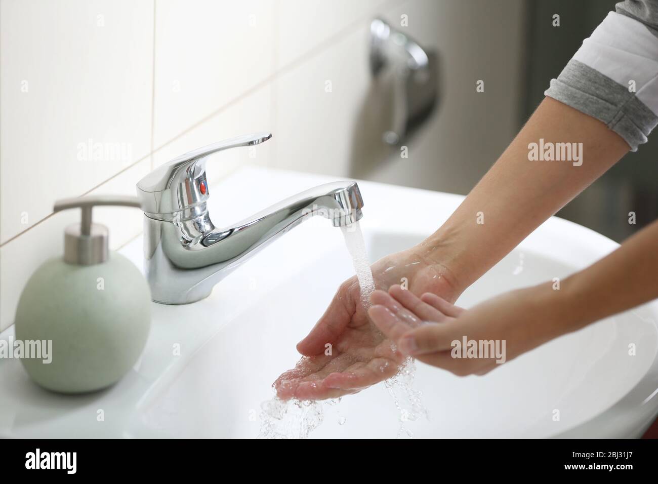 Washing of hands with soap under running water Stock Photo - Alamy