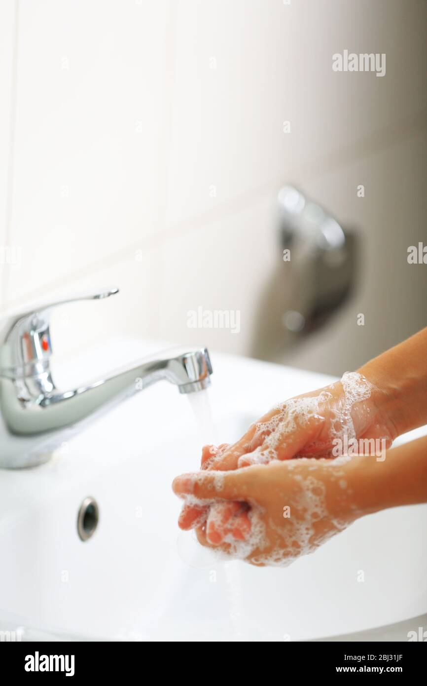 Washing of hands with soap under running water Stock Photo - Alamy