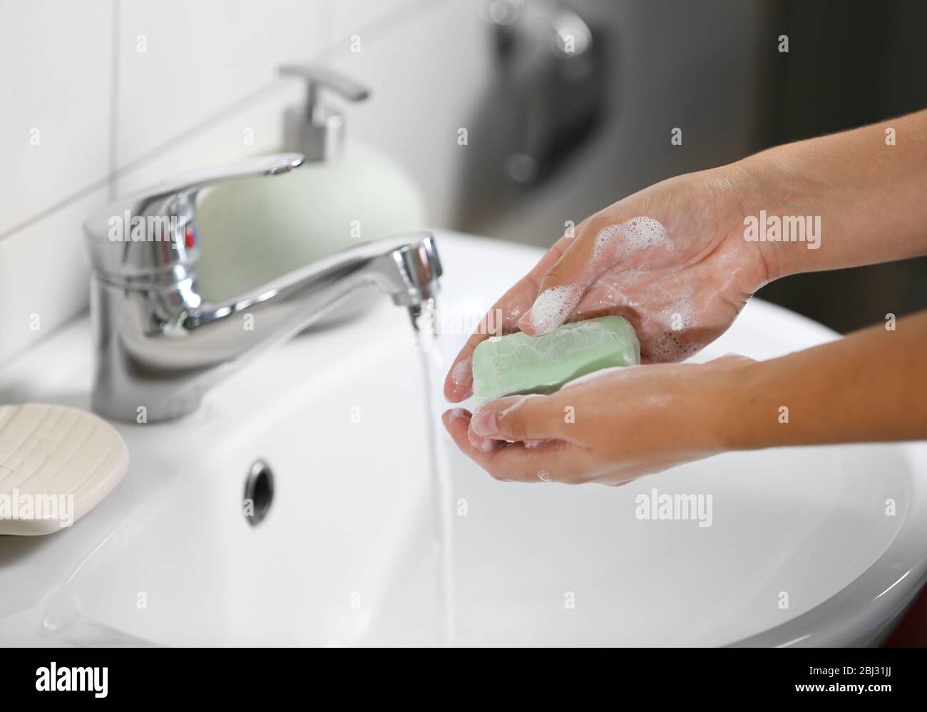 Washing of hands with soap under running water Stock Photo - Alamy
