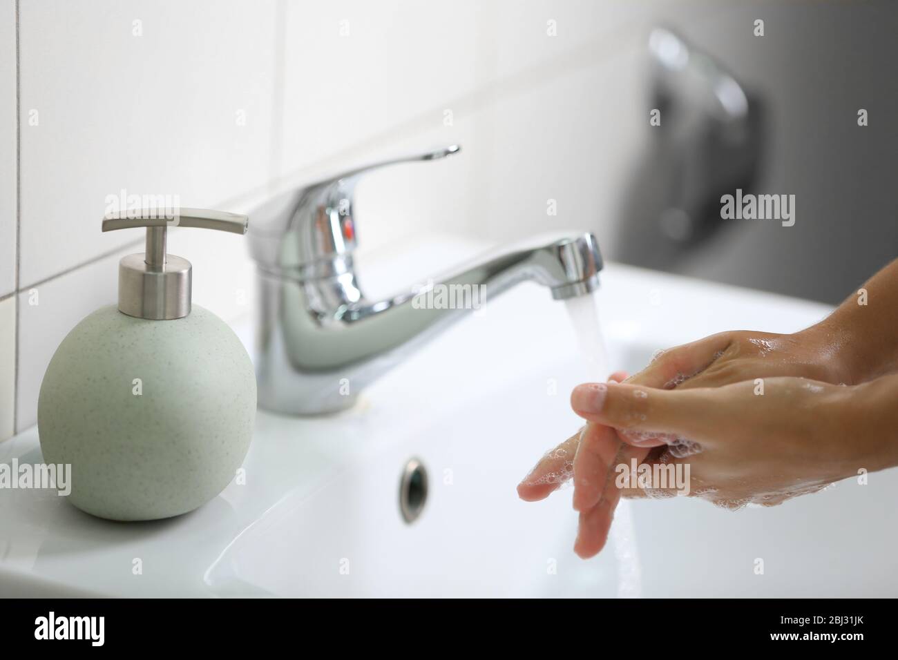 Washing of hands with soap under running water Stock Photo - Alamy