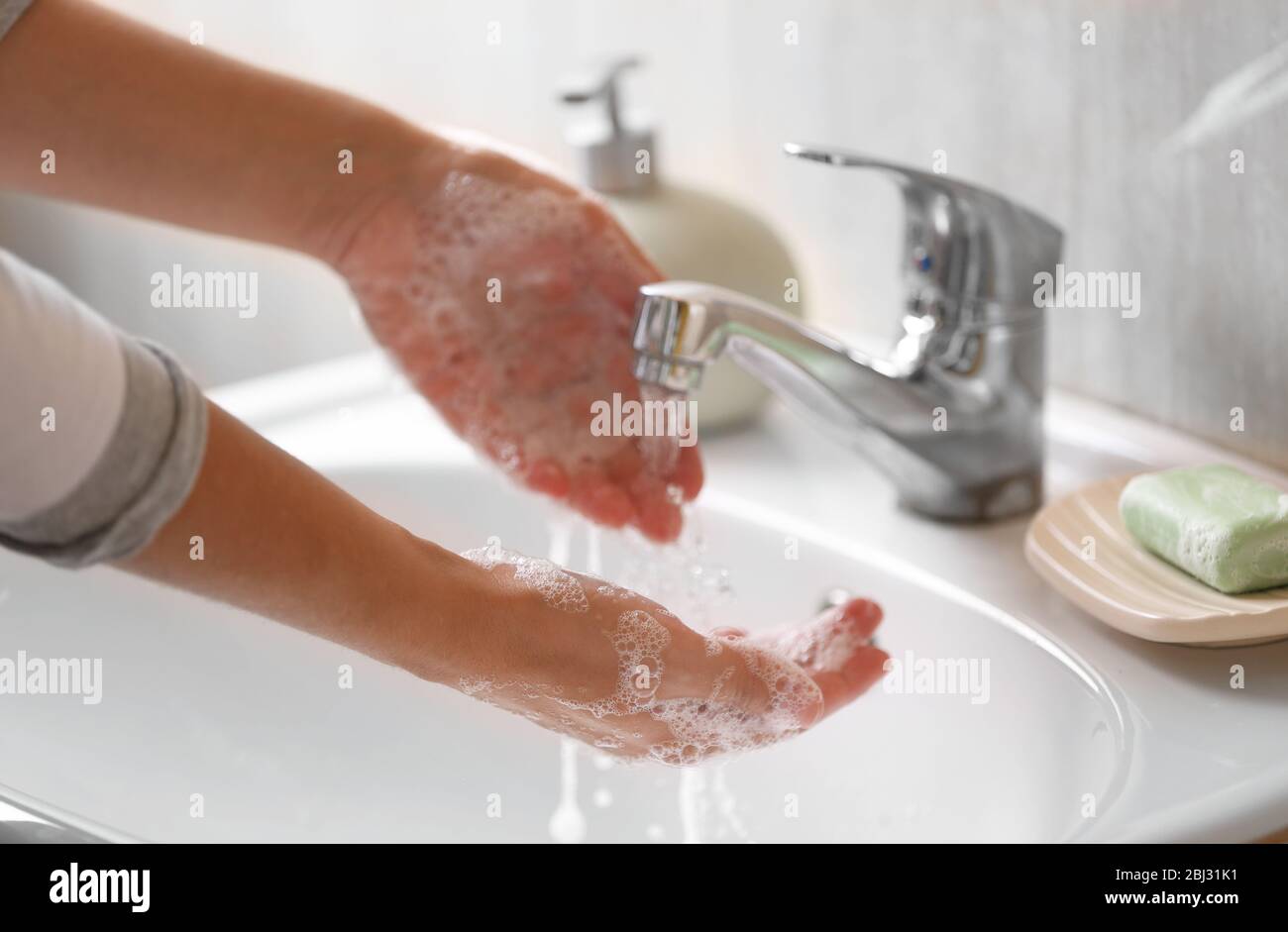 Washing of hands with soap under running water Stock Photo - Alamy
